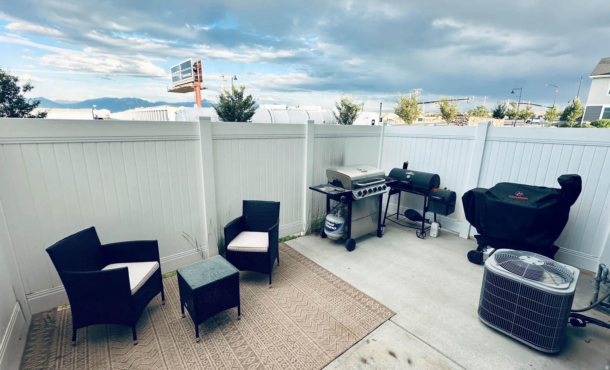 Private patio space featuring a concrete surface and perimeter fencing