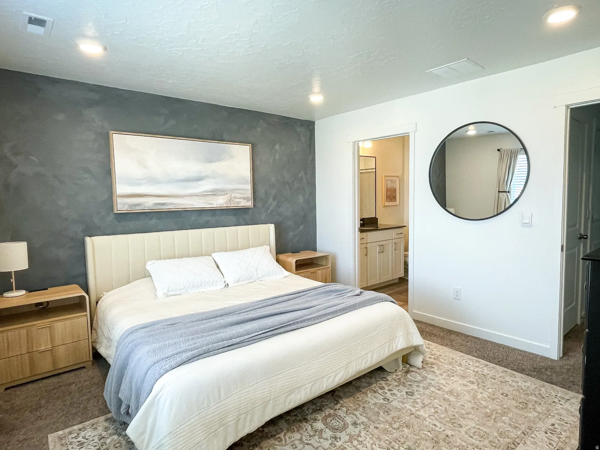 Bedroom featuring a distinct accent wall, recessed lighting, and carpeted flooring