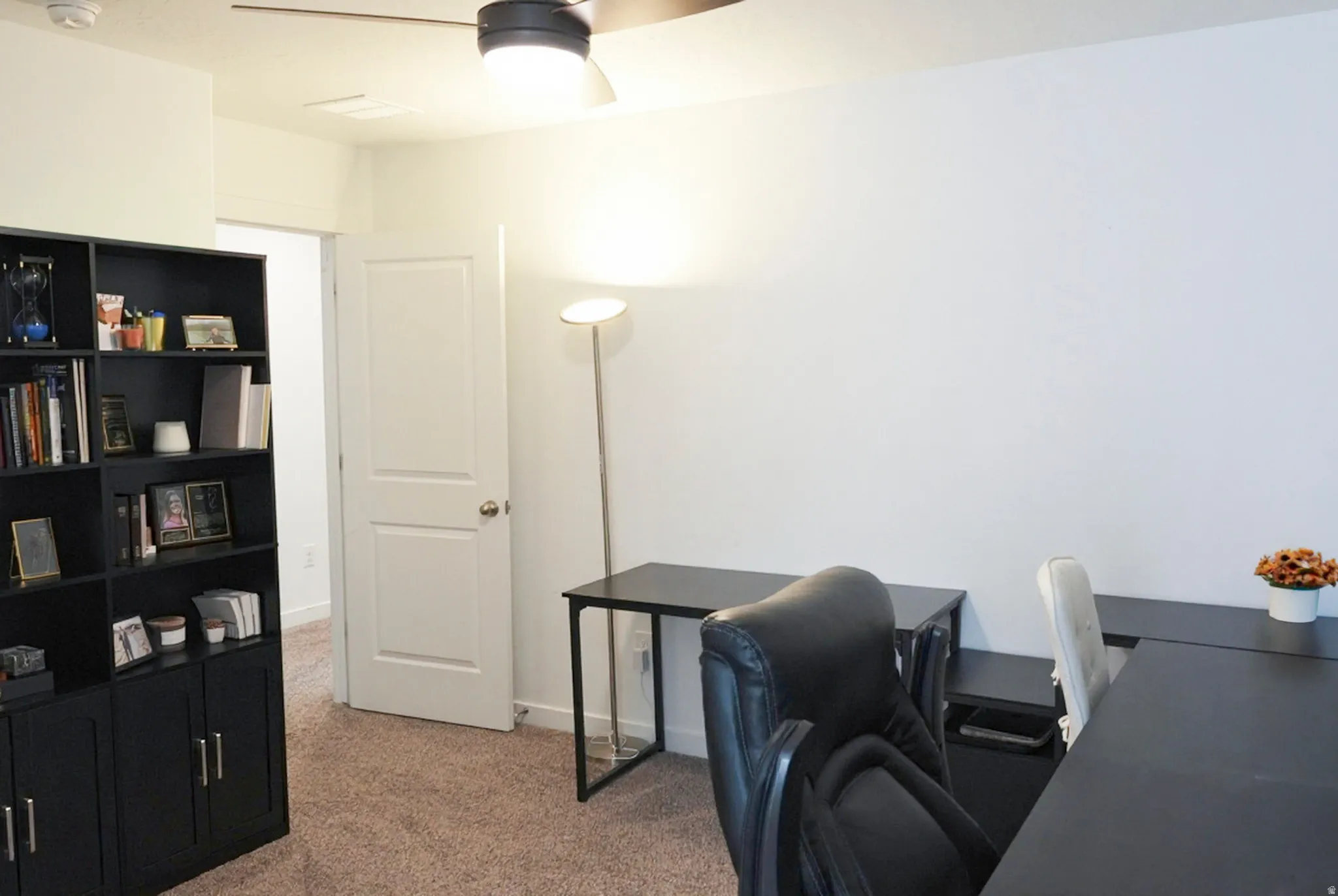 Room featuring a ceiling fan with integrated lighting, neutral carpet flooring, and white walls