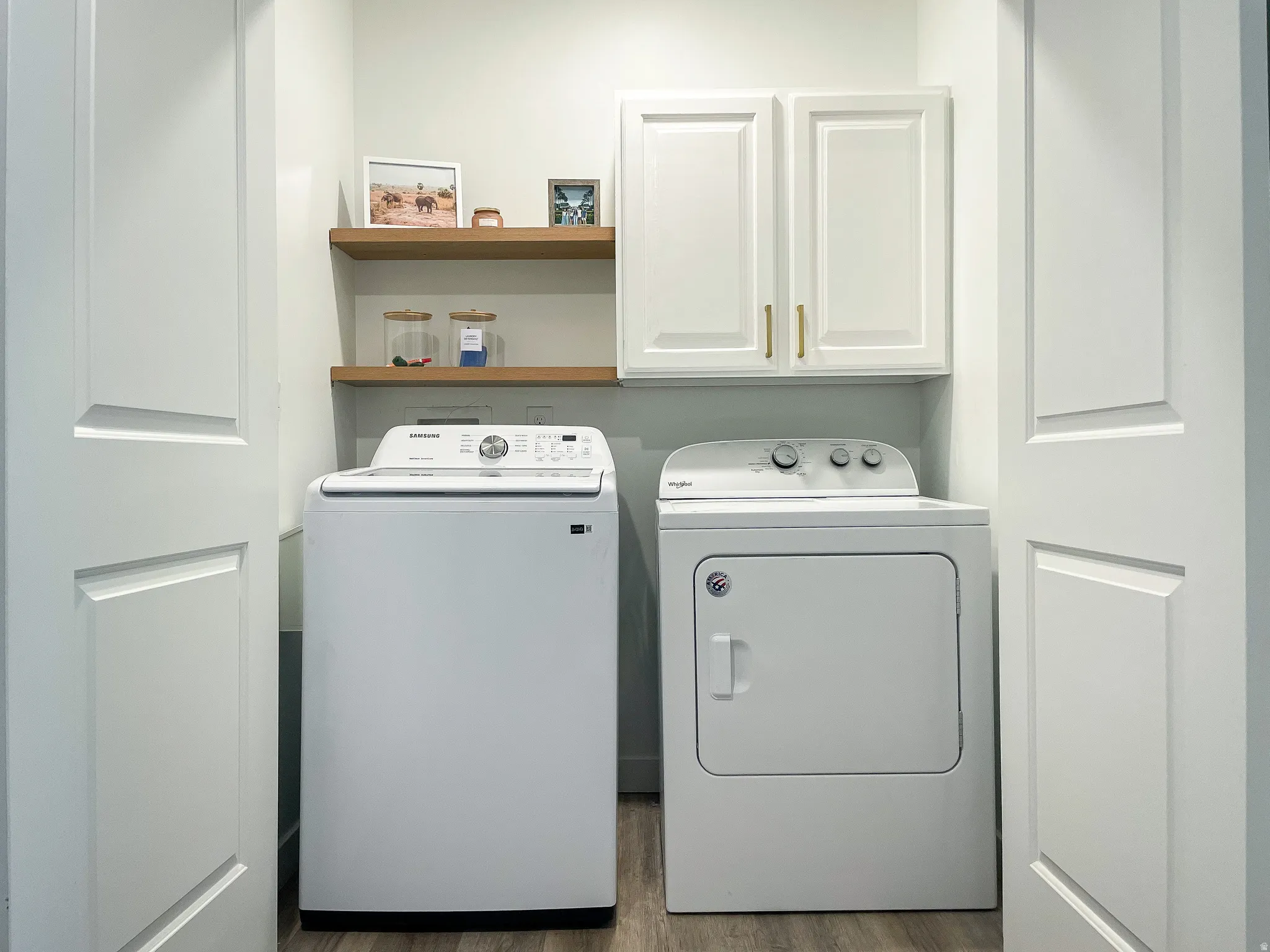 Dedicated laundry area featuring a top-load washing machine and front-load dryer