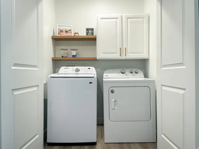 Dedicated laundry area featuring a top-load washing machine and front-load dryer