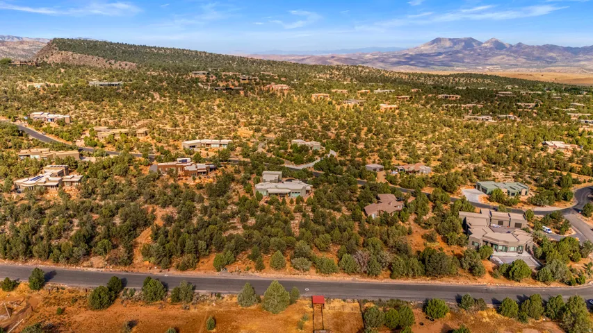 Expansive landscape featuring numerous properties interspersed among natural vegetation