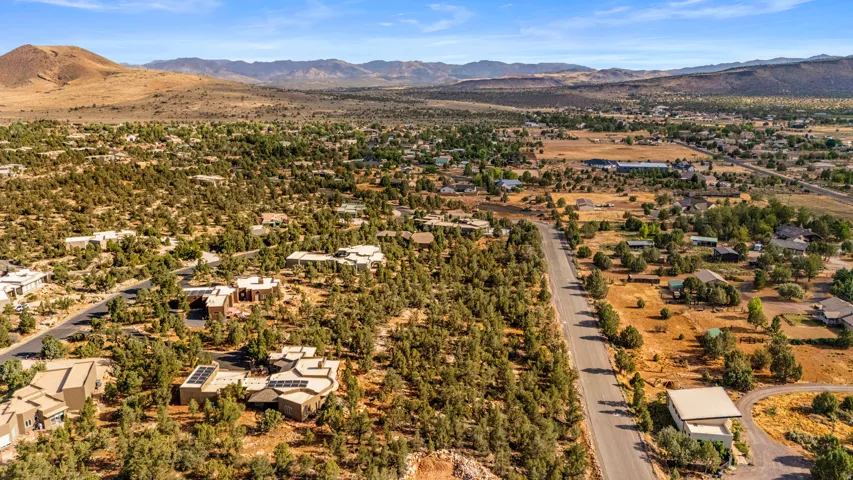 Expansive aerial capturing a desert landscape with scattered residential properties