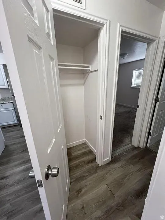 Hallway closet featuring an upper shelf and hanging rod