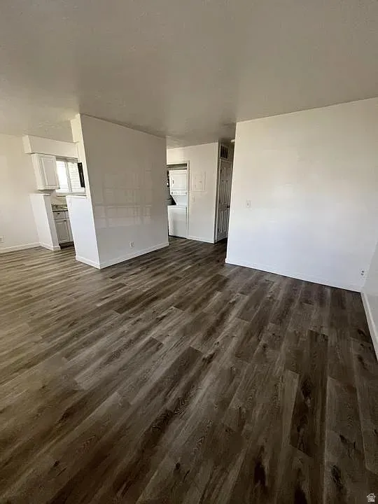 Spacious interior featuring wood-finish flooring, white walls, and bright overhead lighting