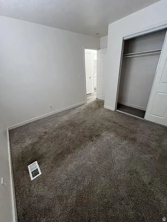 Neutral-toned room with plush carpeting and white walls
