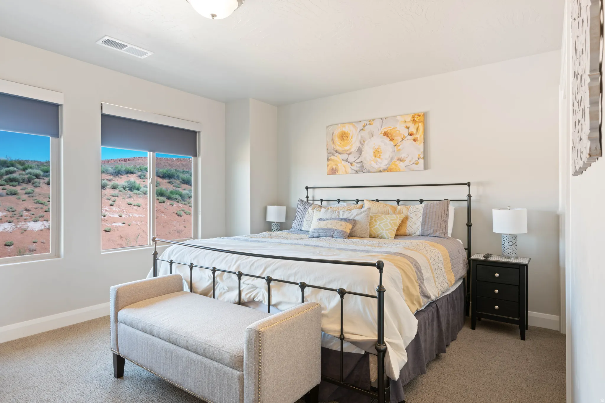 Bright room featuring light-toned walls and carpet flooring