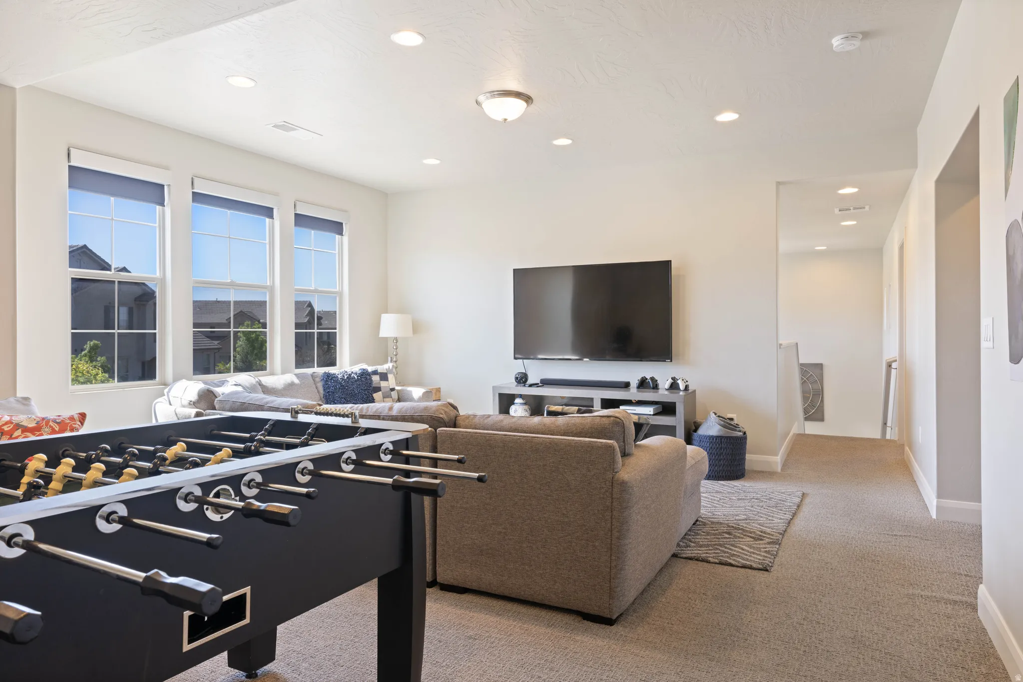Spacious bonus room featuring recessed lighting, a large window array, and neutral wall tones