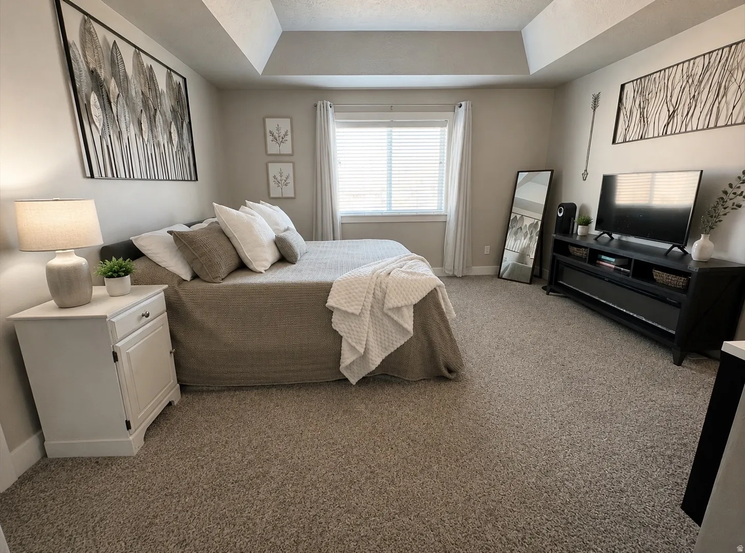Primary Bedroom Suite with Neutral Carpeting, Recessed Ceiling Detail, and Abundant Natural Light from Large Window