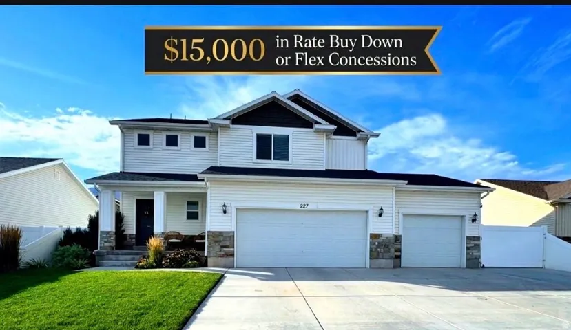 Two-story residence with a 3-car garage, white siding, and stone accents.