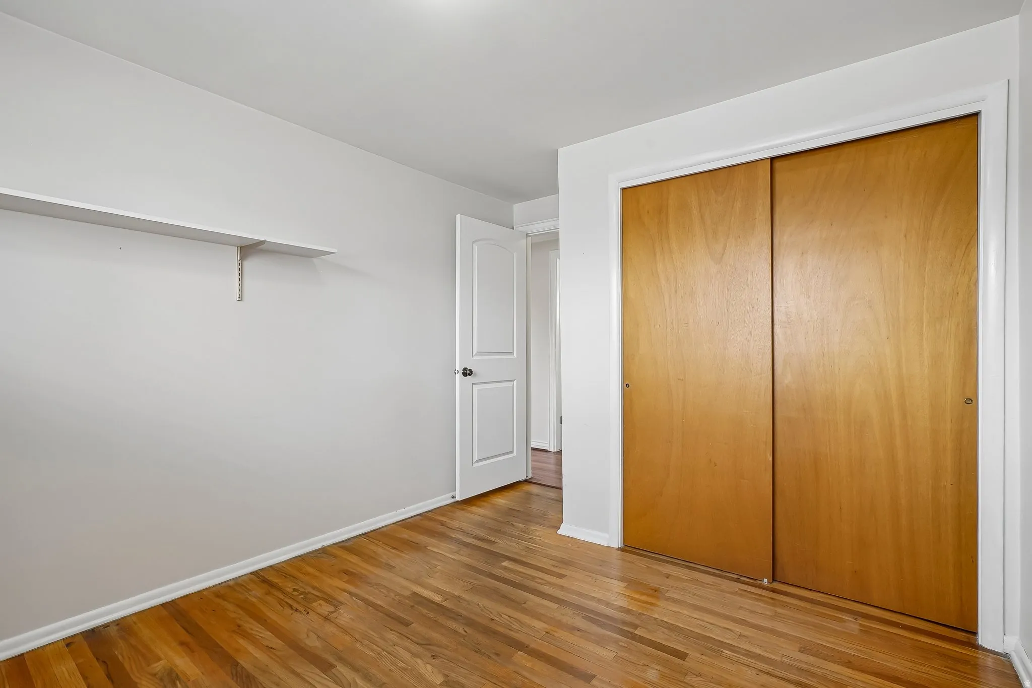 Hardwood flooring complemented by white baseboards and walls