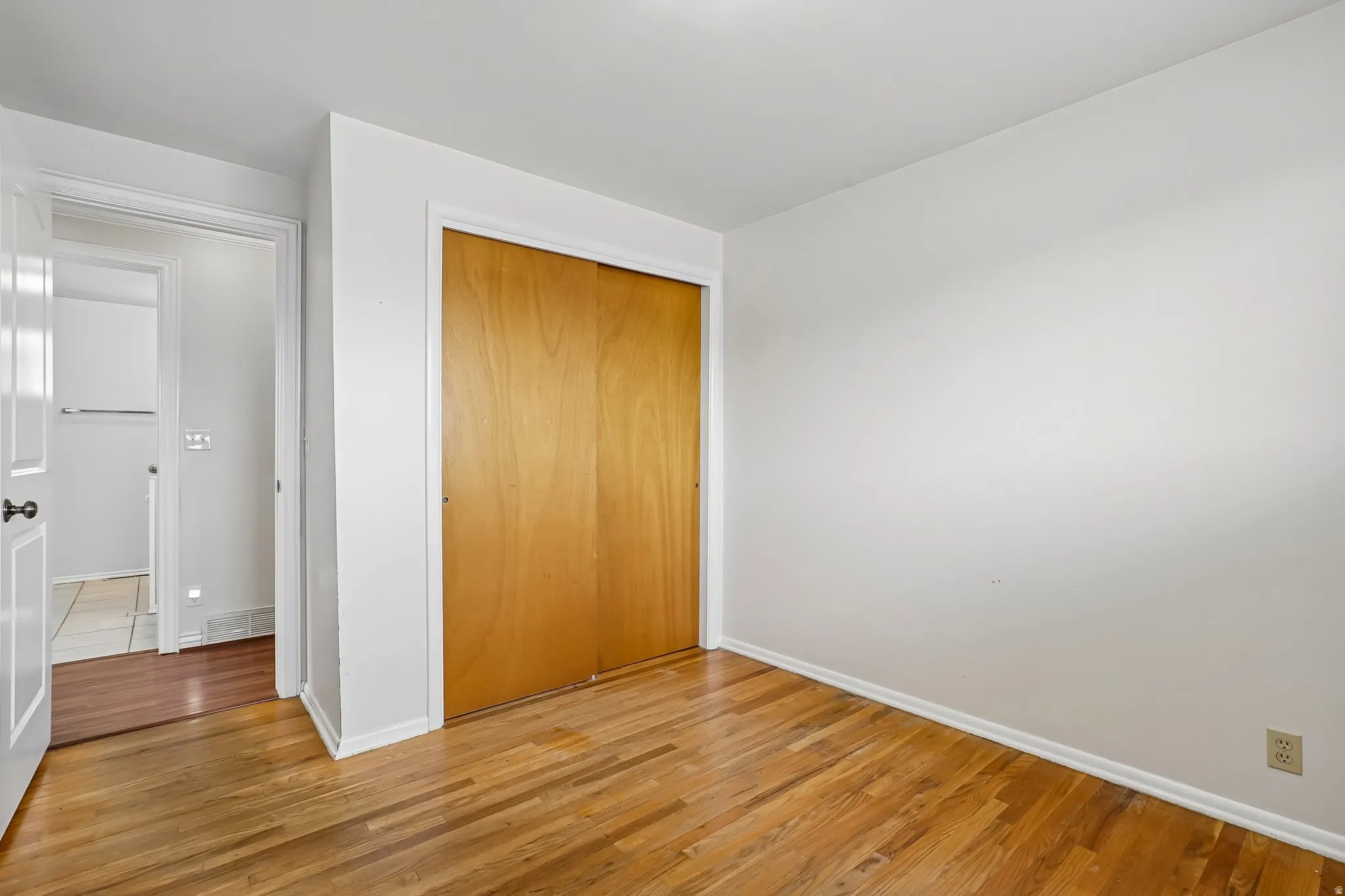 Hardwood flooring and light-toned walls create a neutral palette