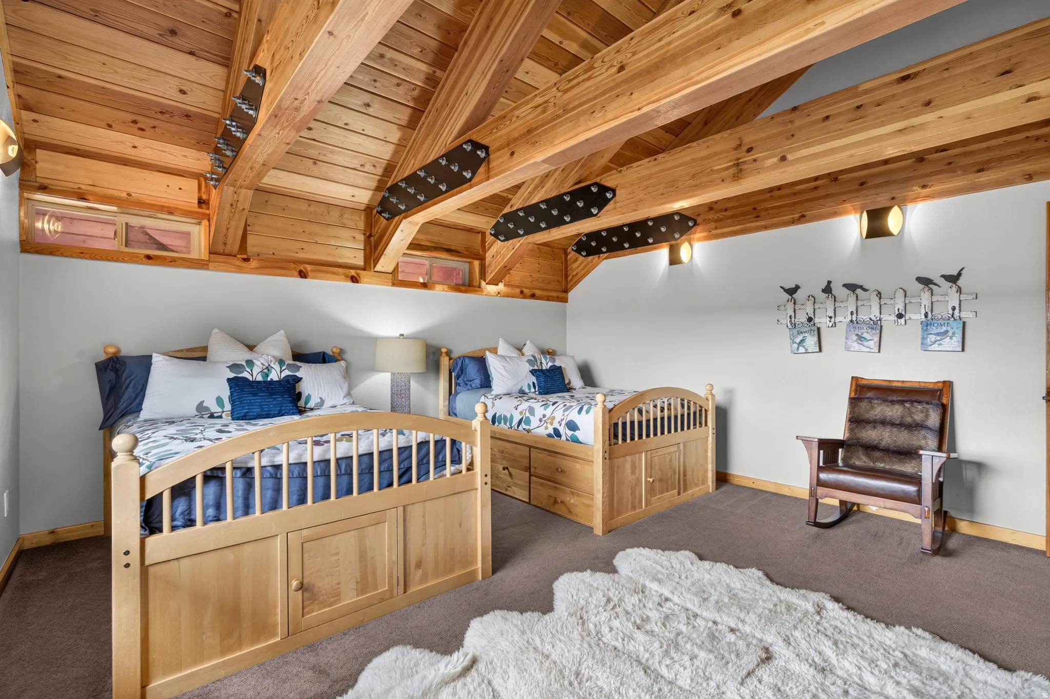 Vaulted wood-finish ceiling with exposed beams and recessed lighting