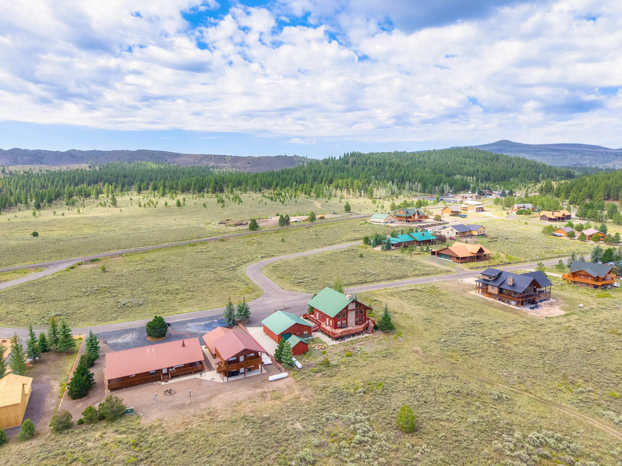 Expansive rural community featuring numerous properties, varied architectural styles, and natural landscaping