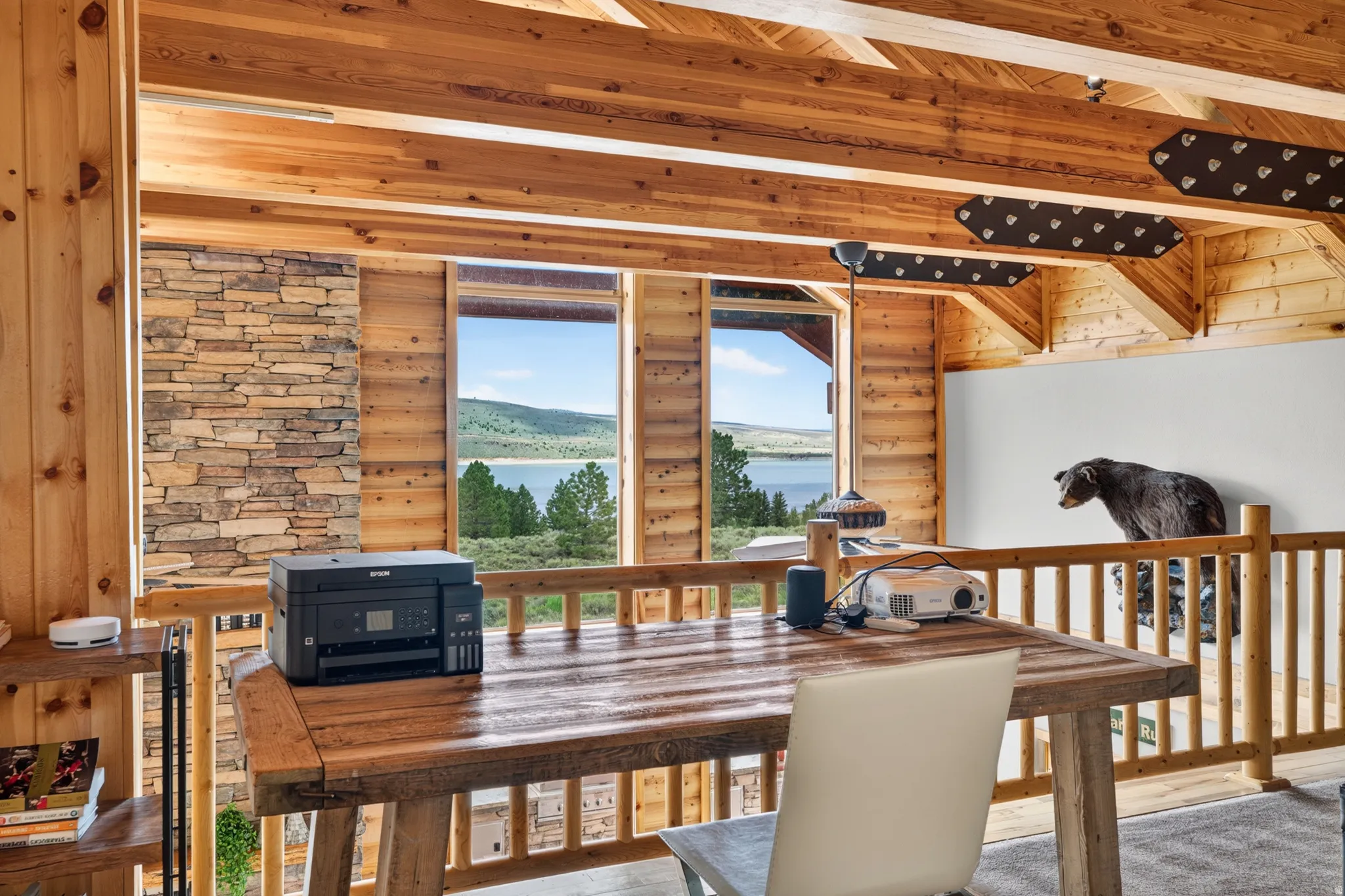 Upper-level area with natural wood beams and a stone-accented wall