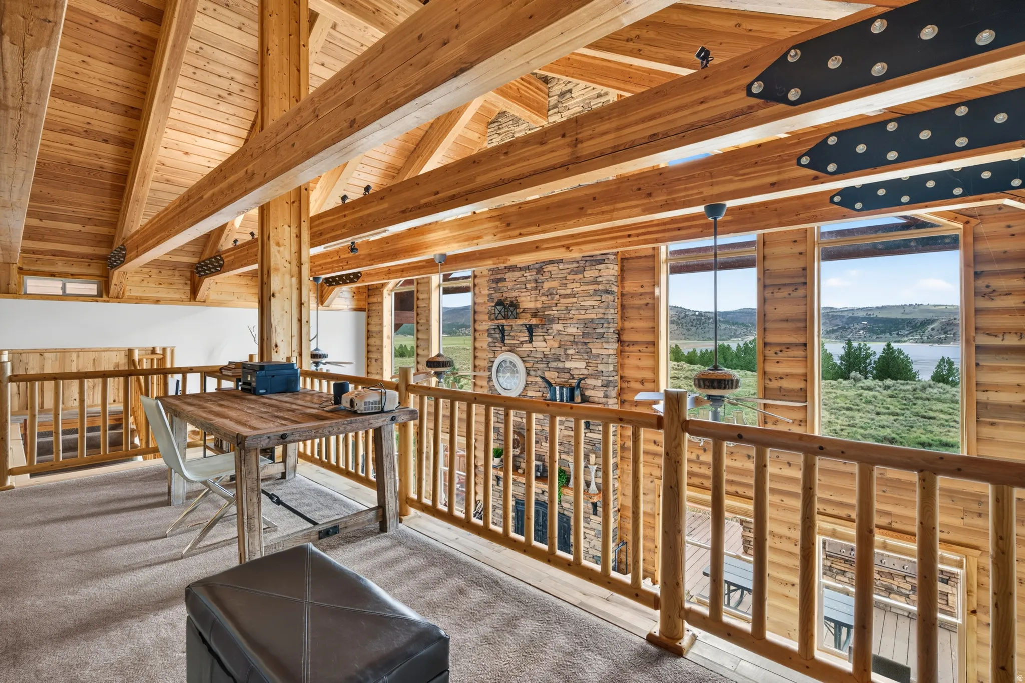 Loft space featuring exposed timber framing and wood-paneled walls