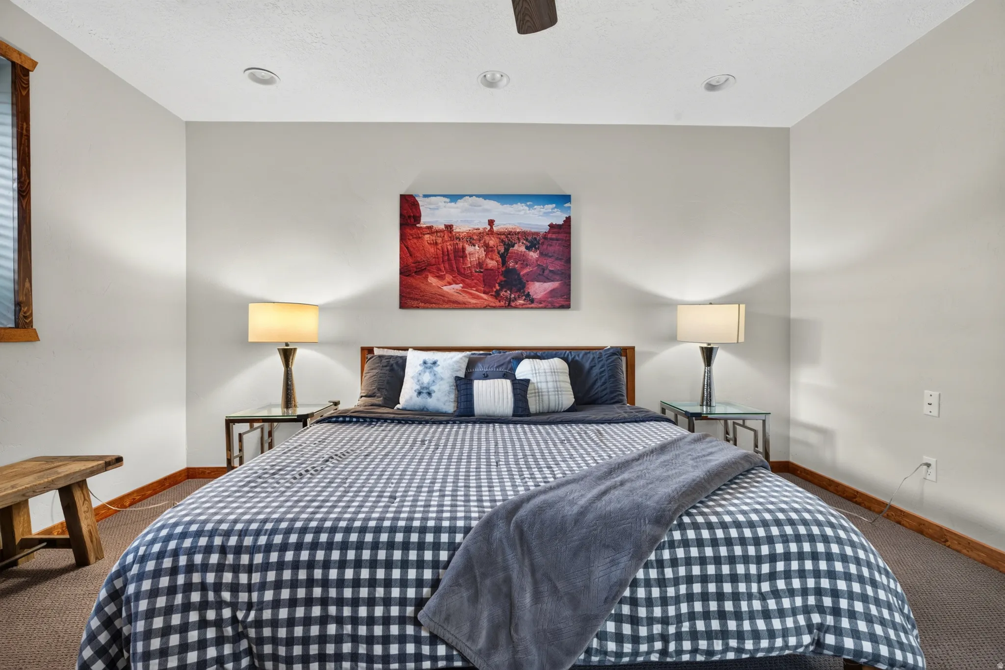 Carpeted room featuring recessed ceiling lighting, a ceiling fan, and a window with wood trim