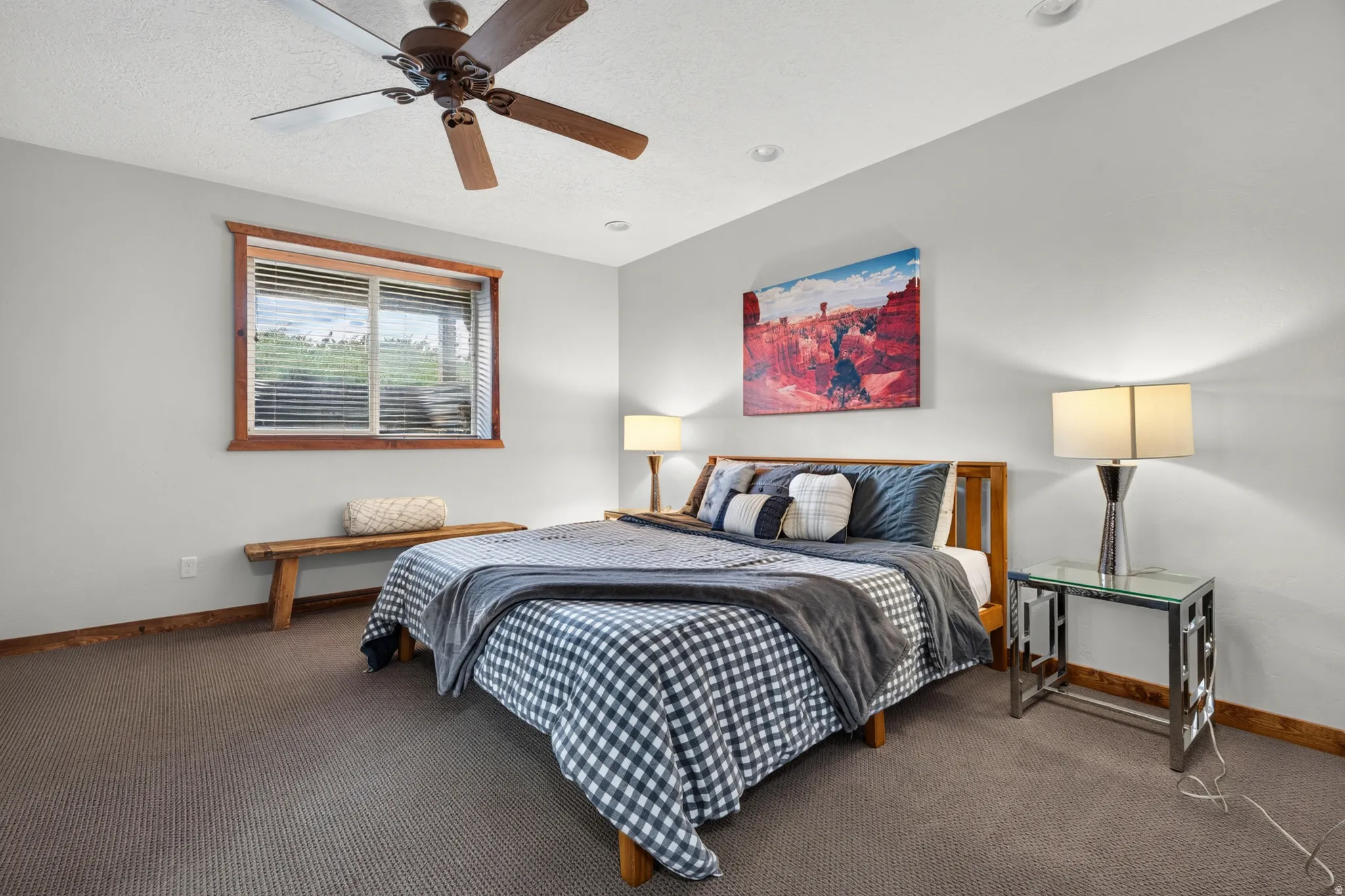 Carpeted bedroom with a window featuring wood trim, a ceiling fan, and recessed lighting