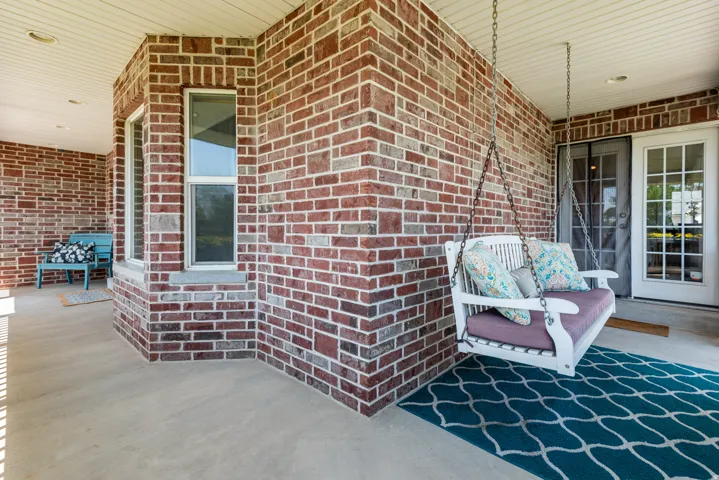 Inviting covered porch with brick facade