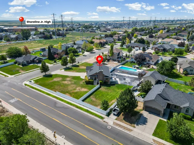 Aerial view showcasing a residential property with a private swimming pool, surrounded by established neighborhood homes