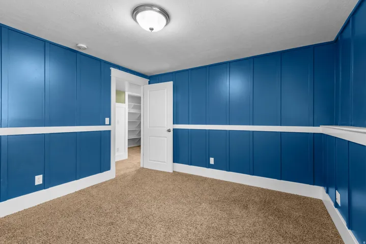 Spacious bedroom with an above grade window.