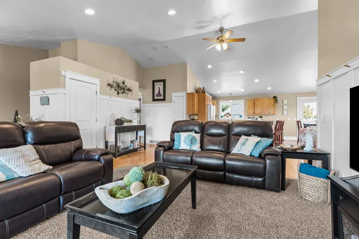 Living area featuring a vaulted ceiling with recessed lighting and a ceiling fan