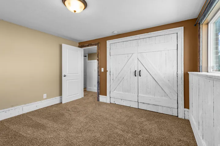 White barn-style doors and matching wainscoting