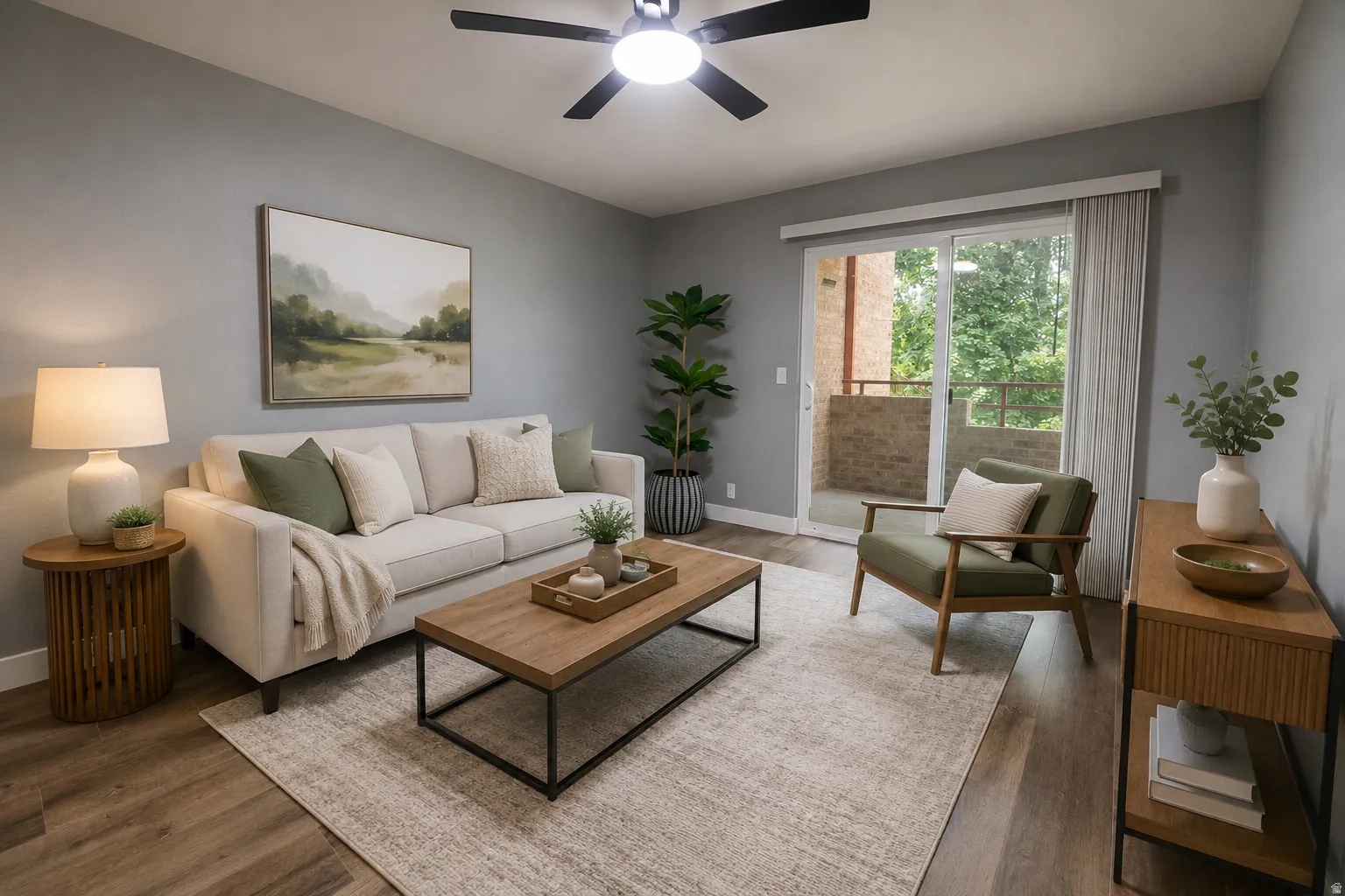 Living area featuring wood-finish flooring, a contemporary ceiling fan with integrated lighting, a sliding glass door with balcony access, and light gray wall paint