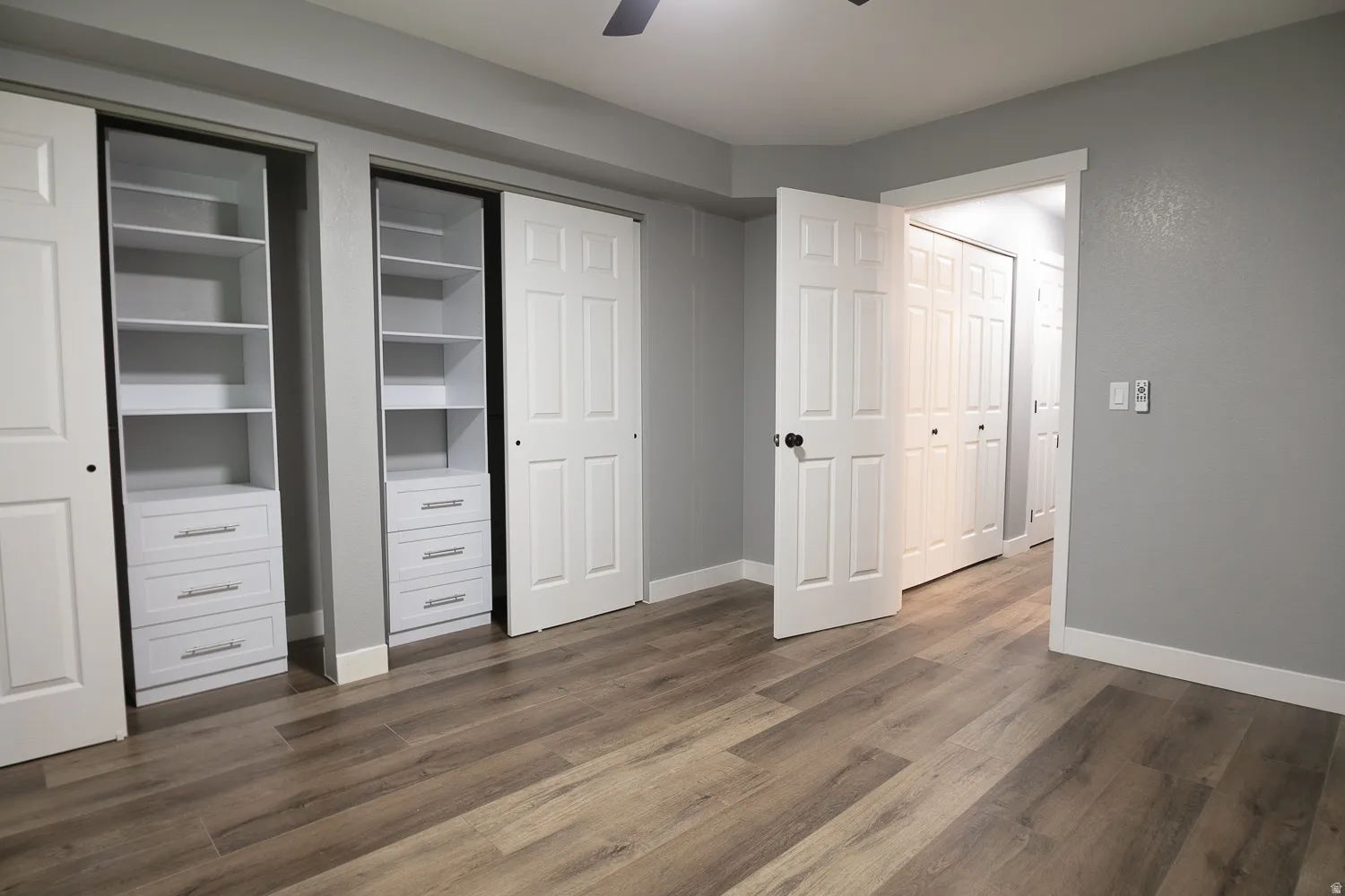 Room featuring wood-finish flooring and light gray walls