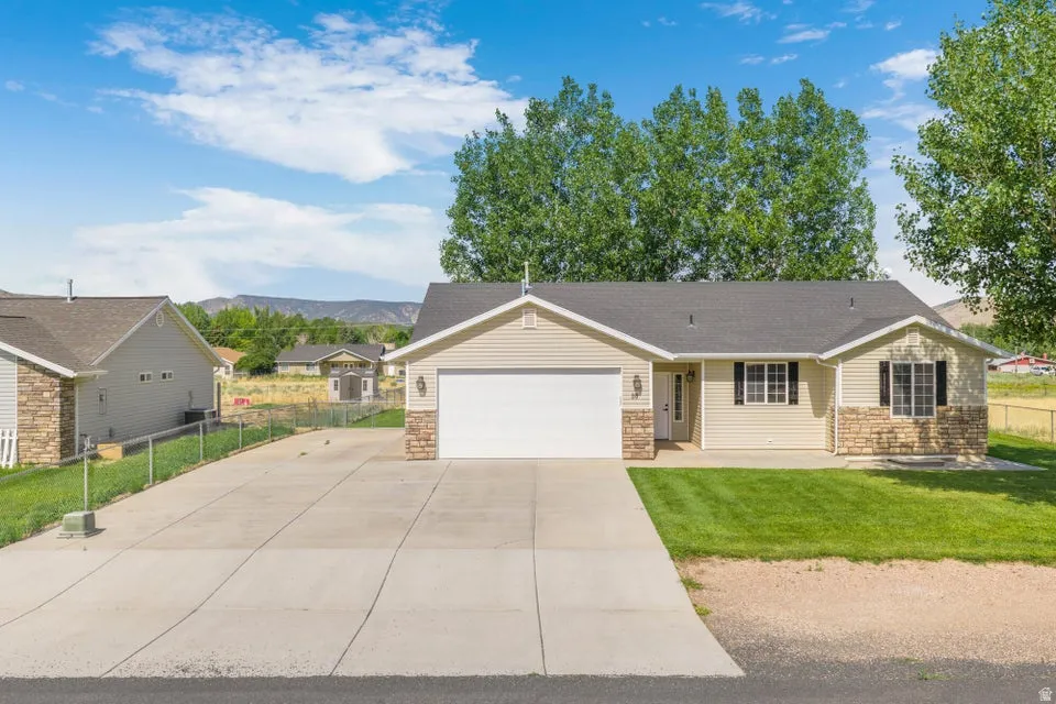 Ranch-style residence featuring a prominent two-car garage