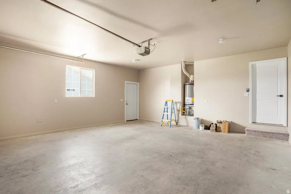 Spacious garage with light beige walls and a concrete floor
