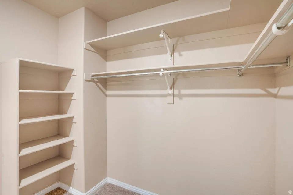 Built-in closet system featuring multiple shelving units and clothing rods
