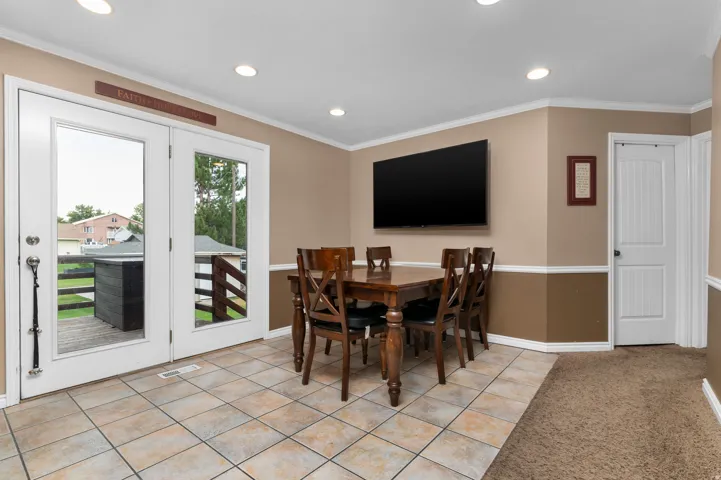 Dining area featuring tile flooring, recessed lighting, and a wall-mounted flat-screen display