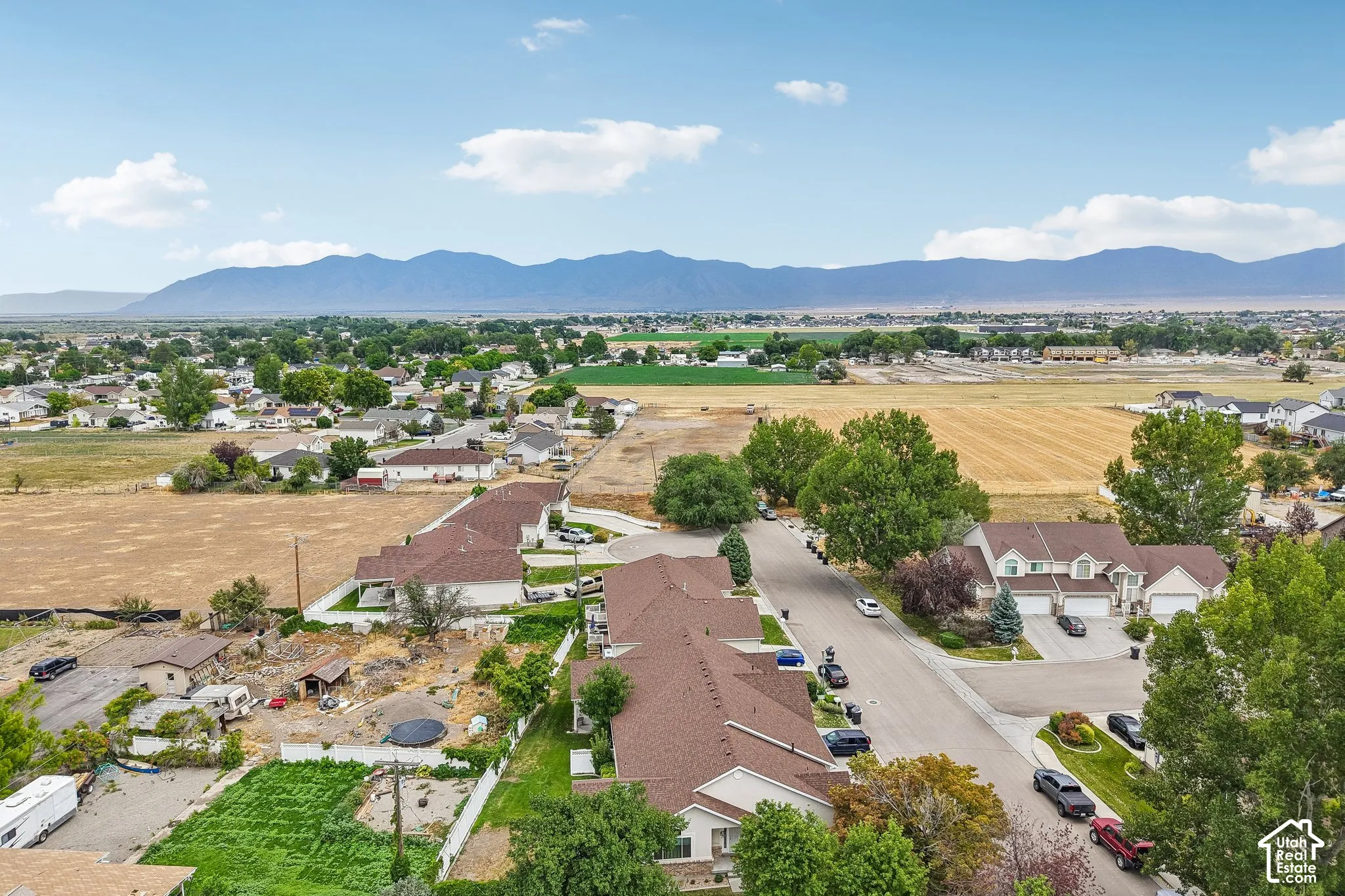 Expansive mountain range backdrop framing a residential area with paved streets
