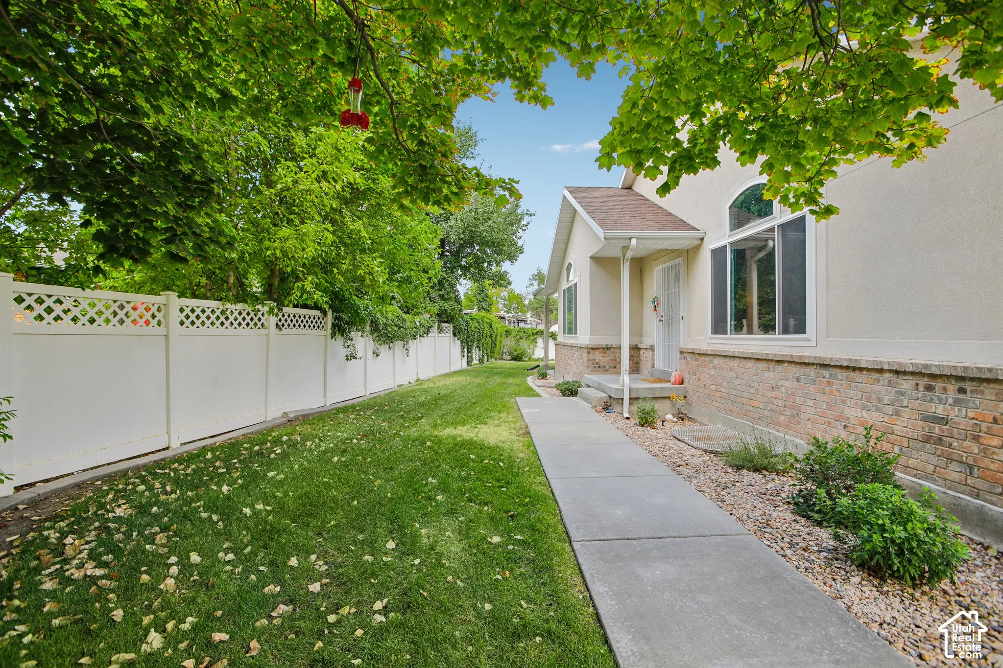 Property exterior featuring a stucco facade with brick accents and a prominent arch window
