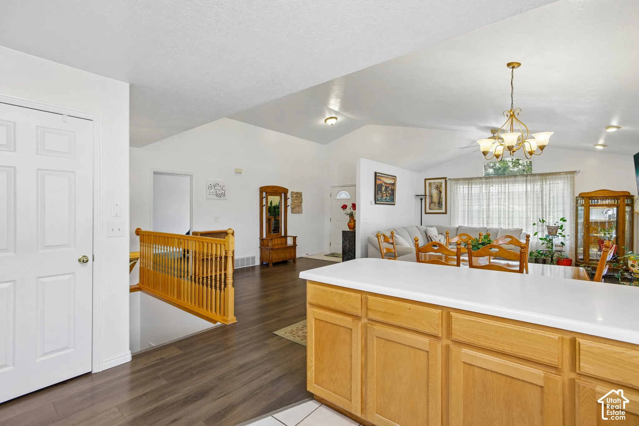Kitchen island featuring light wood cabinetry and a white countertop