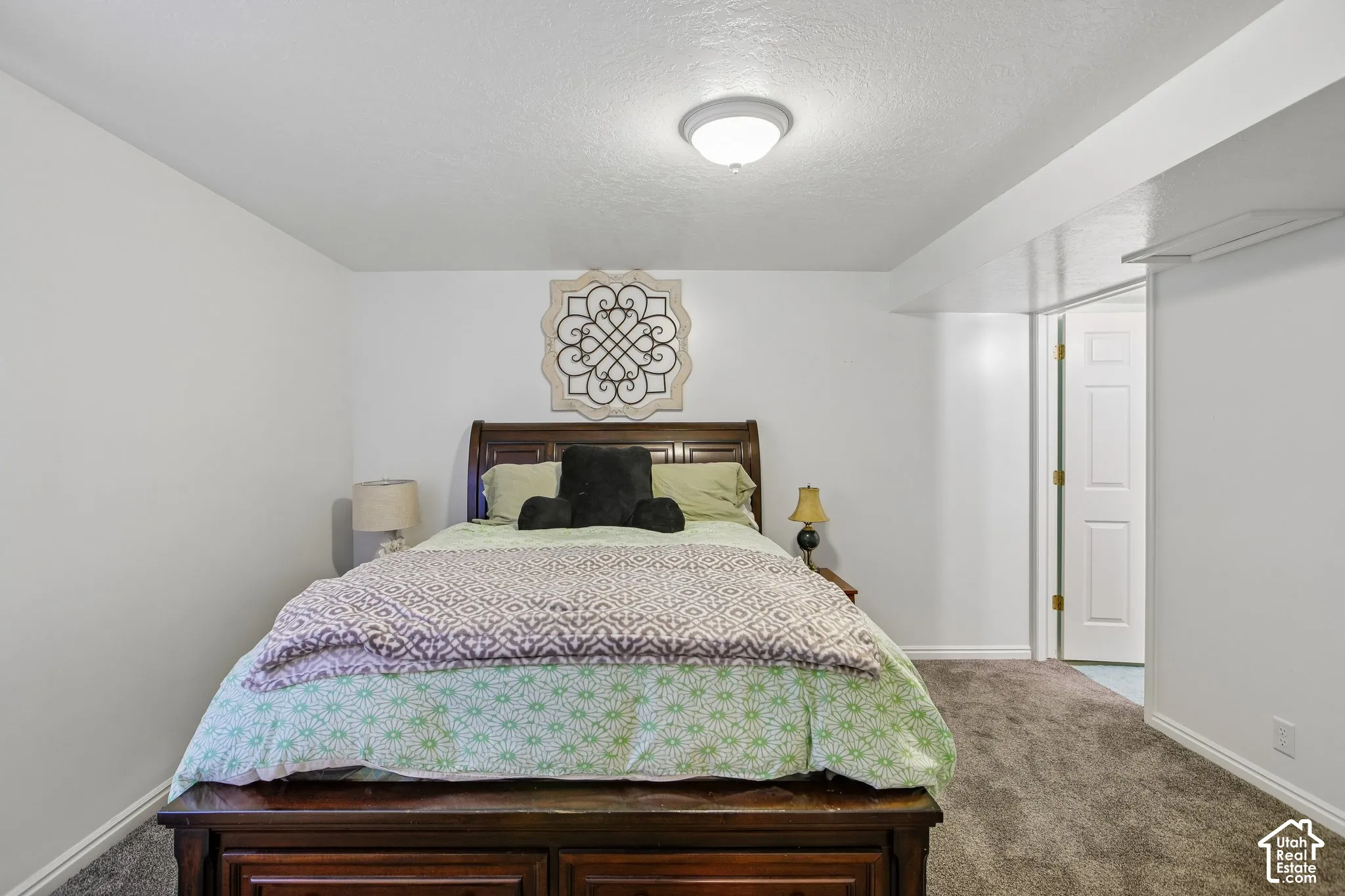 Neutral wall paint contrasting with brown carpet flooring