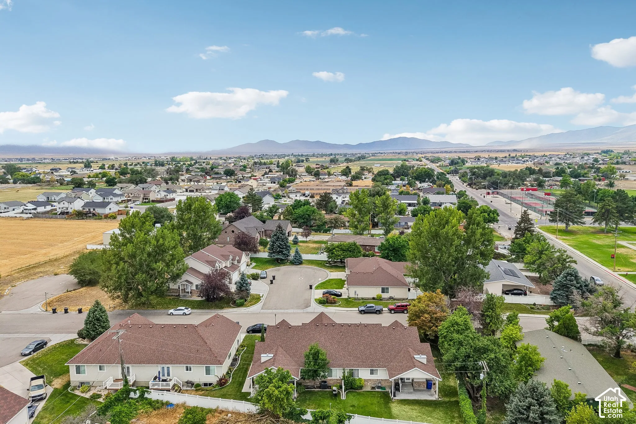 Aerial perspective showcasing a residential neighborhood with distant mountain ranges