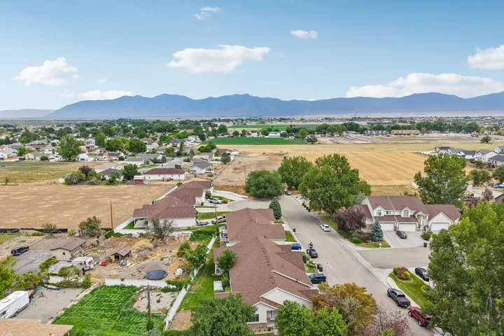 Expansive mountain range backdrop framing a residential area with paved streets