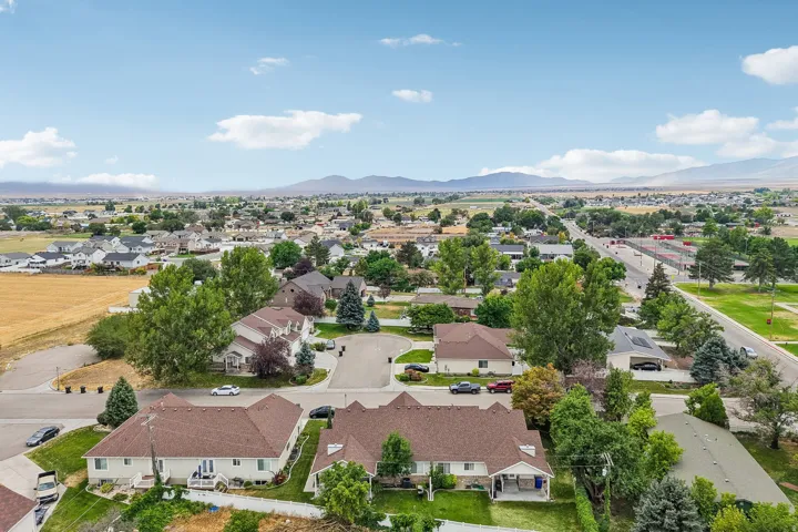 Aerial perspective showcasing a residential neighborhood with distant mountain ranges