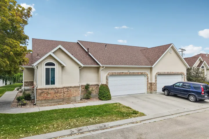 Stucco and brick facade with an arched window accent