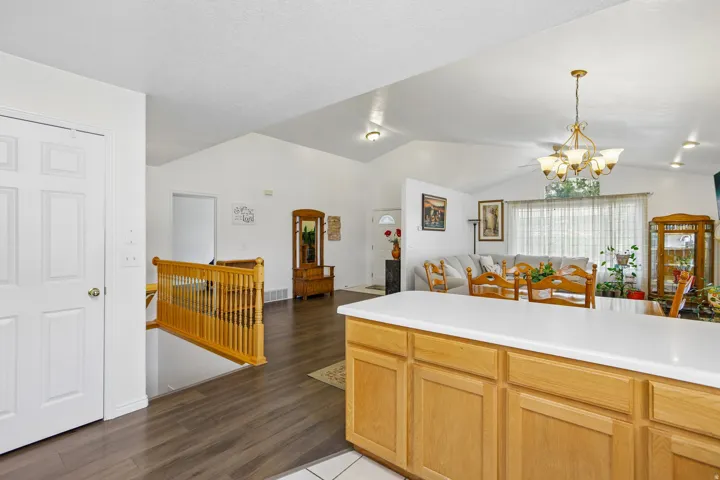 Kitchen island featuring light wood cabinetry and a white countertop