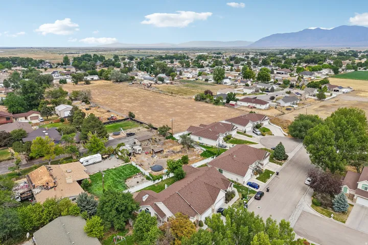 Aerial perspective showcasing a residential neighborhood with distant mountains