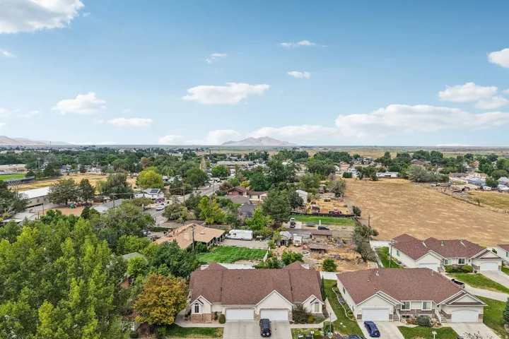 Aerial perspective showcasing residential properties and distant mountain ranges