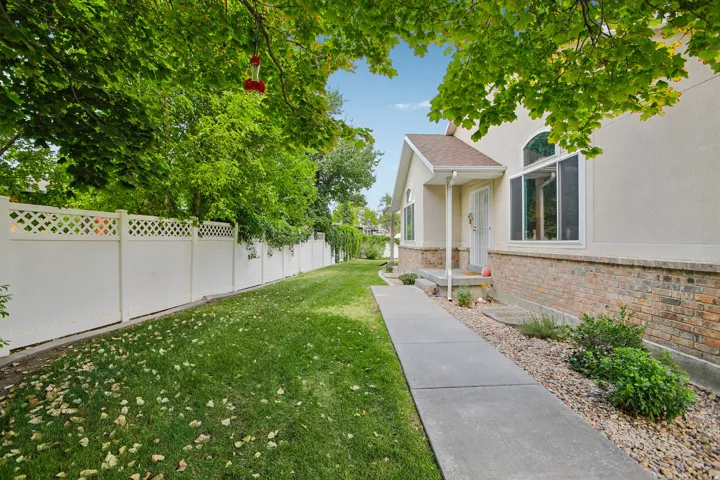 Property exterior featuring a stucco facade with brick accents and a prominent arch window