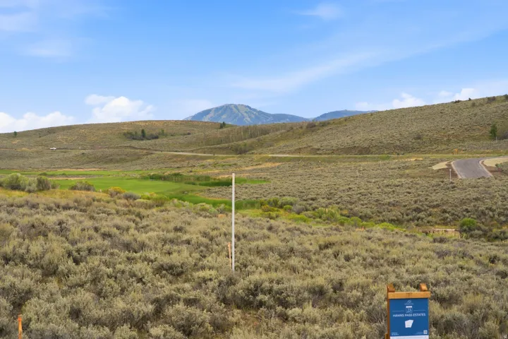 Expansive natural landscape featuring rolling hills and distant mountains