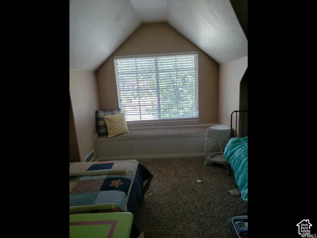 Attic room featuring a spacious window seat with integrated storage