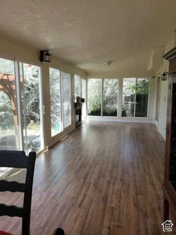 Sunroom featuring wood-finish flooring and extensive window walls