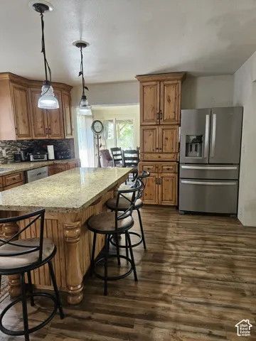 Kitchen featuring wood-finish flooring and pendant lighting