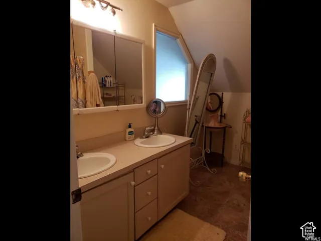 Double vanity with integrated sinks, ample counter space, and under-sink cabinetry